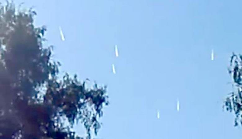 Several white vertical UFOs in the sky above Chile seemed to slowly fall down.