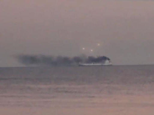 Several UFOs watched a burning American ship