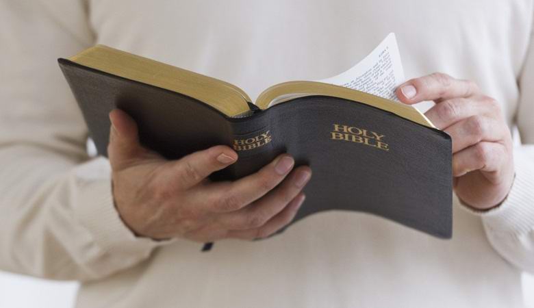 A stranger reading the Bible on a train horrified Londoners.