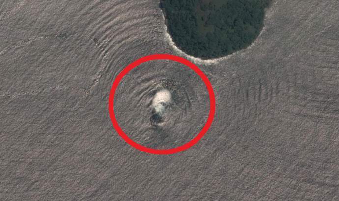 A flying saucer rising from the ocean was found in a satellite image