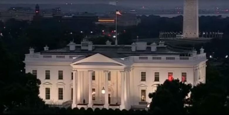 A mysterious red light flashes in the window of the White House